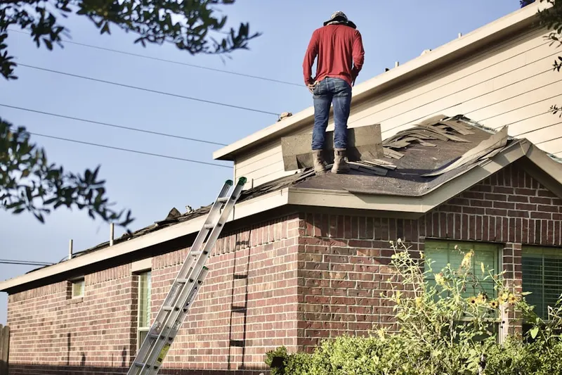 Professional roofer working on a residential roof in Pennsuco